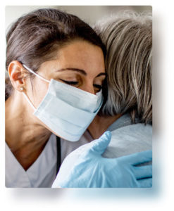 Nurse wearing mask hugging cardiology patient